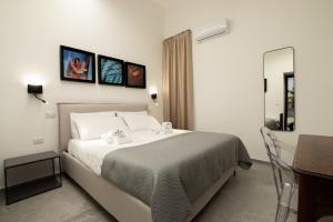 a bedroom with a large bed with two towels on it at APPARTAMENTO - Molo del Porto A in Civitavecchia