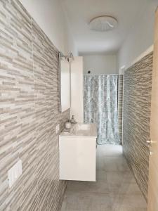 a bathroom with a white sink and a shower at Il Nido in Marina di Montenero