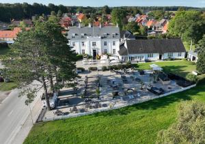 an aerial view of a large white house with a park at Bandholm Badehotel in Bandholm