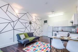 a living room with a couch and a table at Spacious City Centre Retreat in Leeds City Centre in Leeds