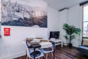 a dining room with a table and chairs at Spacious City Centre Retreat in Leeds City Centre in Leeds