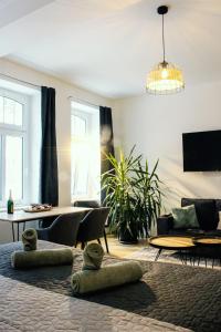 a living room with a couch and a table at NUWILU ONE - Apartment mit Balkon im Herzen Erfurts - Magenta TV- Netflix - Disney in Erfurt