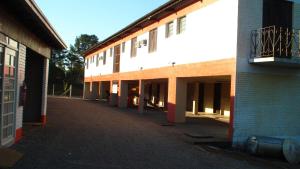 an empty courtyard of a building with a balcony at Classic Hotel e Motel in Santa Cruz do Sul