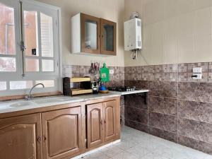 a kitchen with a sink and a counter top at Dar Zakaria Toursitic Area in Tozeur
