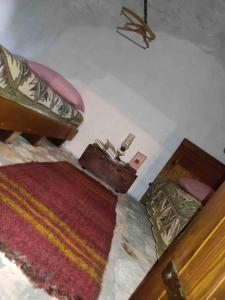 um quarto com 2 camas e um tapete em Old House Piperi em Podgorica