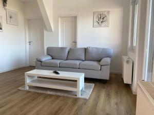 a living room with a couch and a coffee table at Pelster´s Apartments in Diepholz