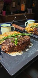 a plate with a piece of meat on a table at 44 on Ennis Guest Lodge and Restaurant - NO LOAD SHEDDDING in Ermelo