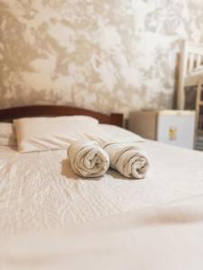 two towels sitting on top of a white bed at Pousada Cabocla in Alter do Chao