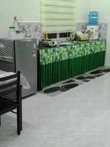 a kitchen with a counter with plants on it at D'Batu Hampar Homestay R2 