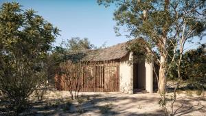 ein kleines Gebäude mit einem Strohdach in der Wüste in der Unterkunft Taru Villas Villu - Wilpattu in Wilpattu Nationalpark