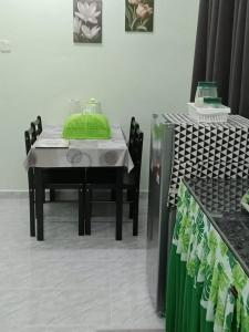 a table and chairs with a green pillow on it at D'Batu Hampar Homestay R2 