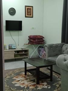 a living room with a couch and a coffee table at D'Batu Hampar Homestay R2 