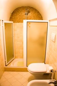 a bathroom with a shower and a toilet and a tub at Dimora Iride in Monopoli +49 photos