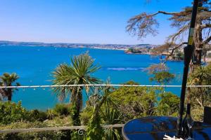 a view of a lake from a balcony at Luxury Riviera View Waterside Apartment in Torquay