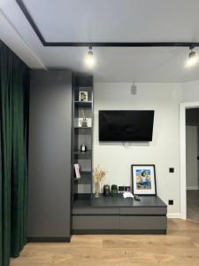 a living room with a flat screen tv on a wall at Апартаменти в центрі Тернополя in Ternopil