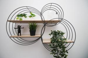 a shelf in the shape of a heart with plants at Cohost Partners Spacious Free Parking in Cardiff