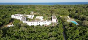 an aerial view of a large white house in the woods at Residence Altair - Serra Degli Alimini 3 in Otranto