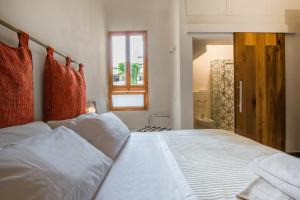 a bedroom with a large white bed and a window at Thousand Dreams Suite in Florence