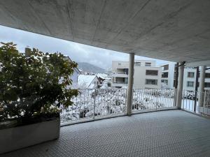 a balcony with a view of a building at Spacious Cozy 2 Bedroom Apartment near Aegerisee in Oberägeri