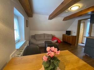 a living room with a table and a couch at Hotel Rotgiesserhaus in Kurort Oberwiesenthal