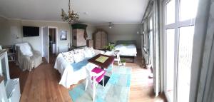 a living room with a bed and a table in it at Ferienhof Altglobsow/ Cafe Seeblick in Großwoltersdorf