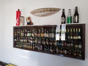 a shelf full of beer bottles on a wall at Casa Nunzia in Domodossola +19 photos