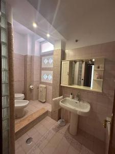 a bathroom with a sink and a toilet at [Centocelle, Metro C] Luminoso quadrilocale in Rome