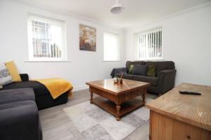 a living room with a couch and a coffee table at 4BR modern house Free Parking Cohost Partners in Newport