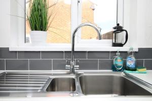 a sink in a kitchen with a window at 4BR modern house Free Parking Cohost Partners in Newport