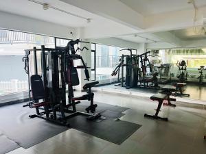 a gym with several tread machines in a room at Vientiane city center modern apartment in Vientiane