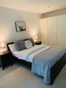 a bedroom with a large bed with two night stands at Impeccable 2-Bed Apartment in Orpington in Orpington