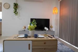 a living room with a table and a tv at Entire house in Pimpama in Gold Coast