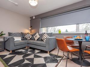 a living room with a couch and a table at Pass the Keys Horsforth Haven-Spring Hideout-Love is in the Aire in Pudsey