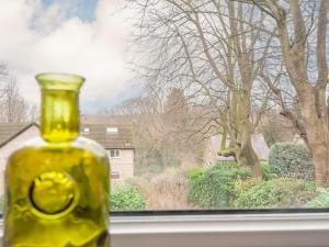 a yellow bottle sitting on a window sill at Pass the Keys Horsforth Haven on the banks of the River Aire in Pudsey