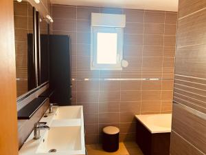 a bathroom with a sink and a window at LA MARIEFACTURE - Comme un Tour du Monde 