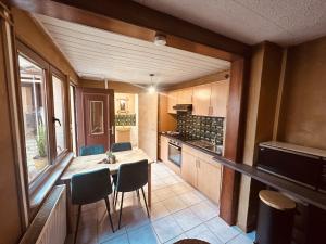 a small kitchen with a table and chairs in it at LA MARIEFACTURE - Comme c'est Jungle in Hombourg-Haut