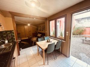 a kitchen and dining room with a table and chairs at LA MARIEFACTURE - Comme c'est Jungle in Hombourg-Haut