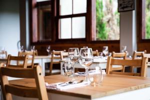 a table in a restaurant with wine glasses on it at Aldeia da Cuada in Faja Grande
