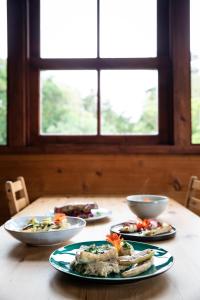 a table with three plates of food on it at Aldeia da Cuada in Faja Grande