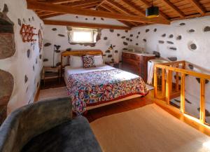 a bedroom with a bed and a wooden wall at Aldeia da Cuada in Faja Grande +37 photos