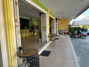 a patio with tables and chairs on a building at Baan Keang Talay Cha Am in Cha Am +19 photos