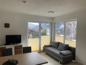 sala de estar con sofá y ventana grande en Appartement Alexandra, en Flattach