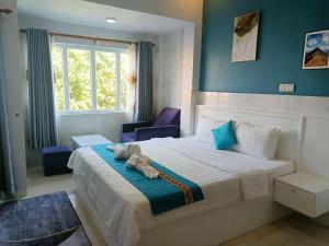 a bedroom with a bed with a stuffed animal on it at Green Garden Guesthouse in Kampot
