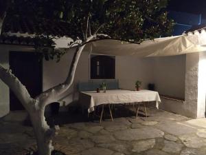 einen weißen Tisch und einen Baum in einem Gebäude in der Unterkunft Casa Rural en Montellano (53km de Sevilla) in Montellano