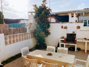 a table and chairs on a patio with a building at Casa Cristina in Vinarós