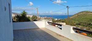 a balcony of a house with a view of the ocean at SunShine House in Ermoupoli