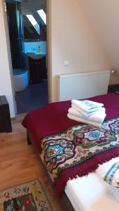 a bed with a pile of towels on top of it at Pensiunea IULIA in Rod +42 photos