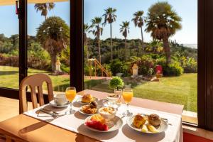 a table with plates of food and glasses of orange juice at Hotel Casabela in Ferragudo +39 photos
