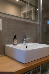 a bathroom sink with a bottle of soap on it at Im Herzen der Stadt - EG Wohnung in Paderborn