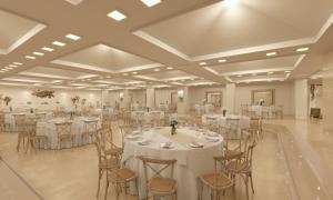 a large banquet hall with white tables and chairs at Meliá Lloret de Mar in Lloret de Mar